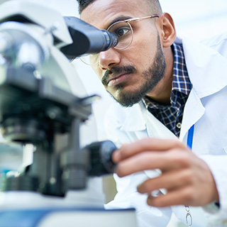 Formulation scientist looking into a microscope